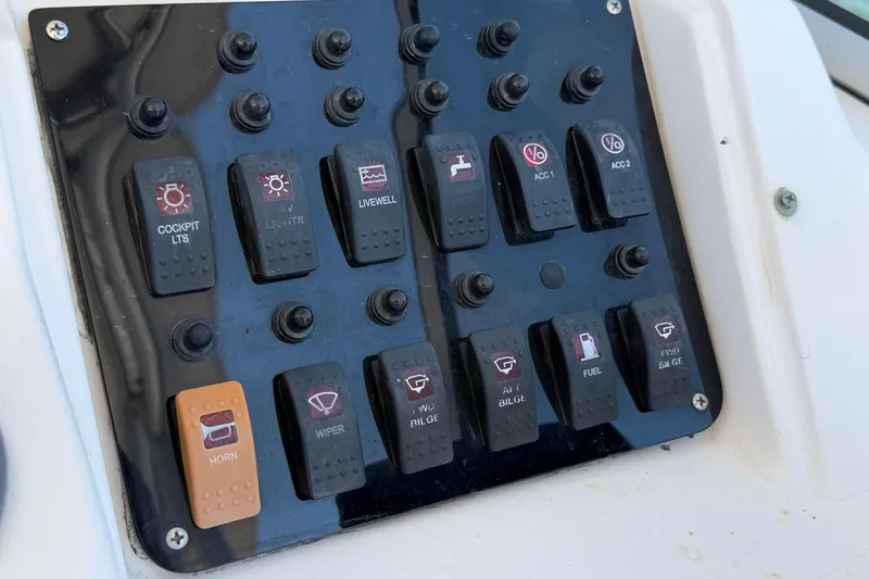Slide: The Image of Control panel of a 1996 Grady-White Marlin 300 boat with labeled switches. - 10