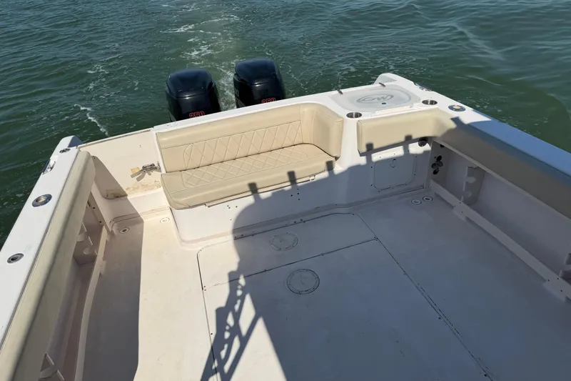 Slide: The Image of 1996 Grady-White Marlin 300 boat deck with twin outboard motors on water. - 11