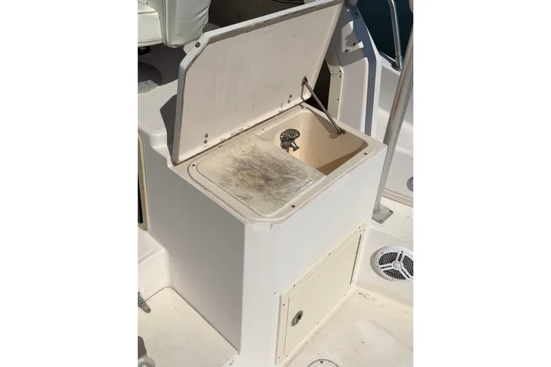 Slide: The Image of 1996 Grady-White Marlin 300 boat sink with open lid and faucet. - 12