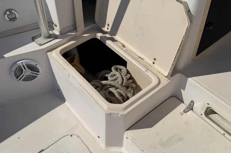 Slide: The Image of Storage compartment on a 1996 Grady-White Marlin 300 boat with coiled rope inside. - 13