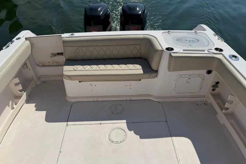 Slide: The Image of 1996 Grady-White Marlin 300 boat interior with cushioned seating and twin outboard motors. - 14