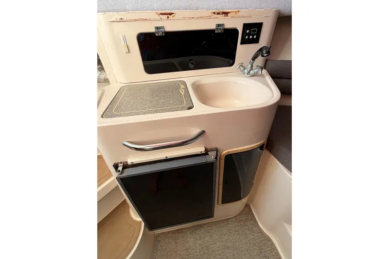 Slide: The Image of 1996 Grady-White Marlin 300 boat interior with sink and storage compartments. - 16