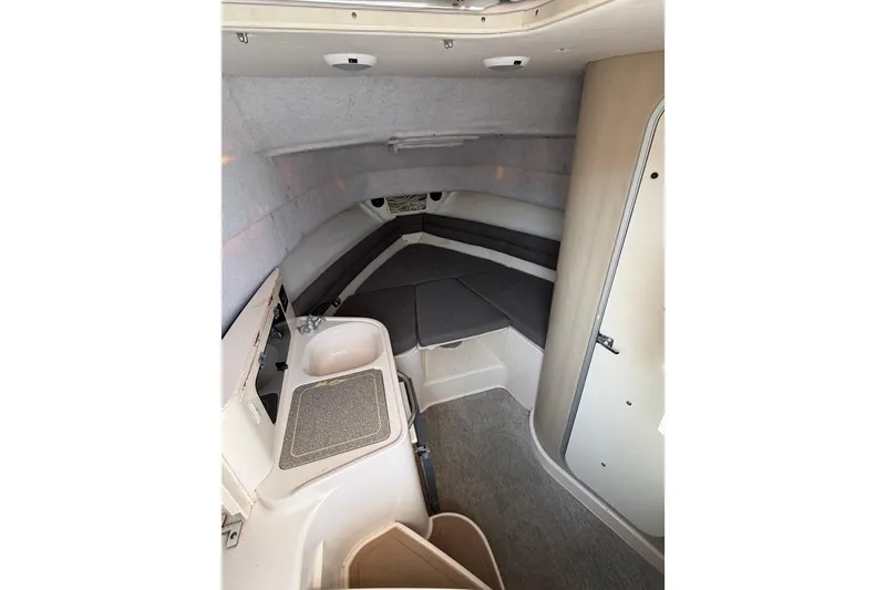 Slide: The Image of 1996 Grady-White Marlin 300 cabin interior with compact sink and seating area. - 17