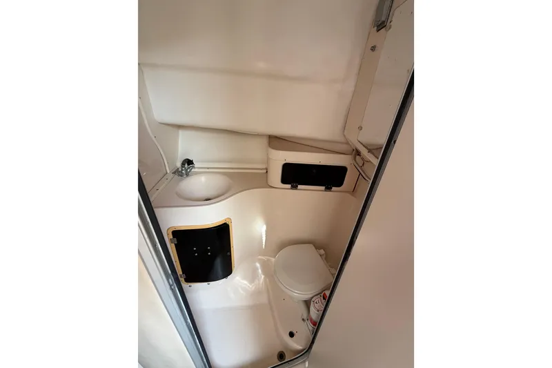 Slide: The Image of 1996 Grady-White Marlin 300 boat bathroom interior with sink and toilet. - 21