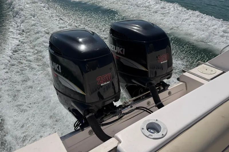 Slide: The Image of Twin Suzuki 250 outboard engines powering a 1996 Grady-White Marlin 300 boat. - 7