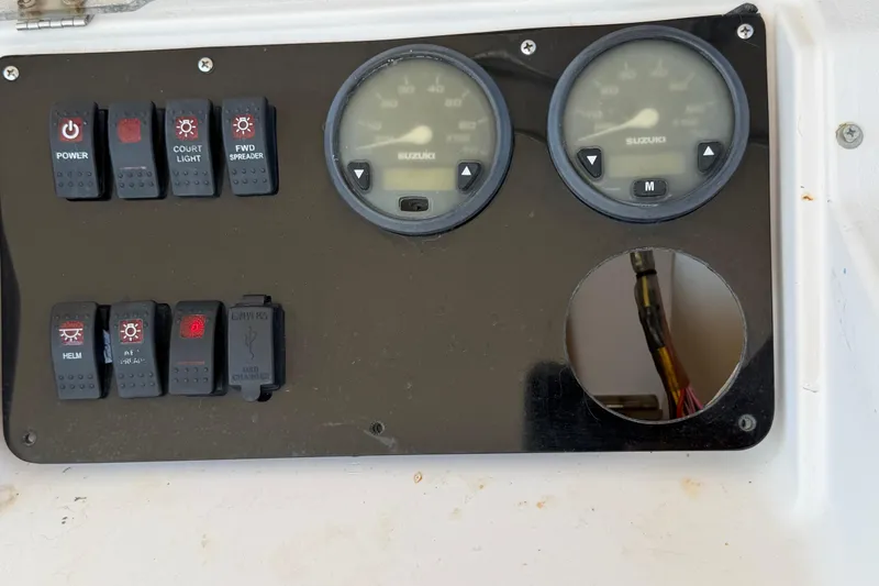 Slide: The Image of Control panel of a 1996 Grady-White Marlin 300 boat with switches and gauges. - 9