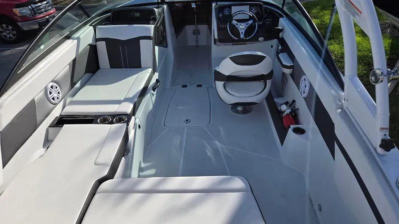 Slide: The Image of 2023 Monterey M225 boat interior with seating, steering wheel, and modern design features. - 3