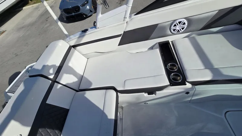 Slide: The Image of 2023 Monterey M225 boat interior with cushioned seating and cup holders. - 7