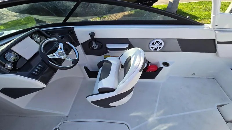 Slide: The Image of 2023 Monterey M225 boat interior with steering wheel and seating. - 8