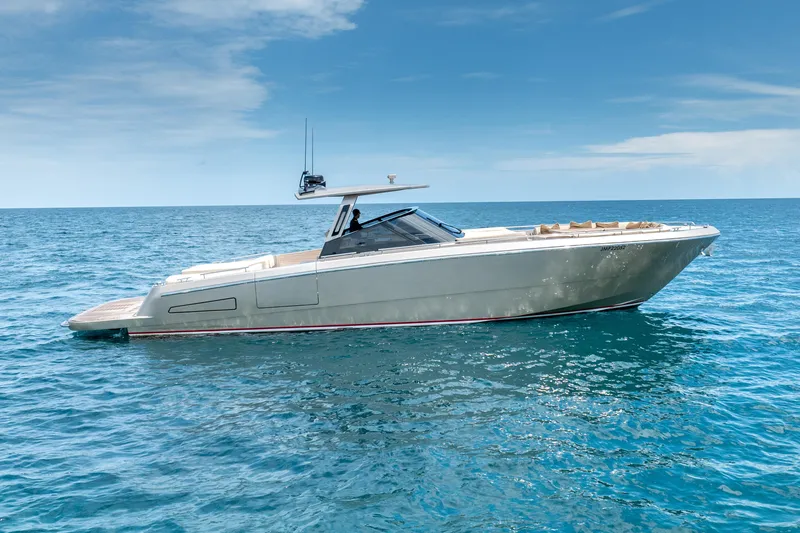 Slide: The Image of 2019 CNM Continental 54 yacht cruising on open sea under clear blue sky. - 10