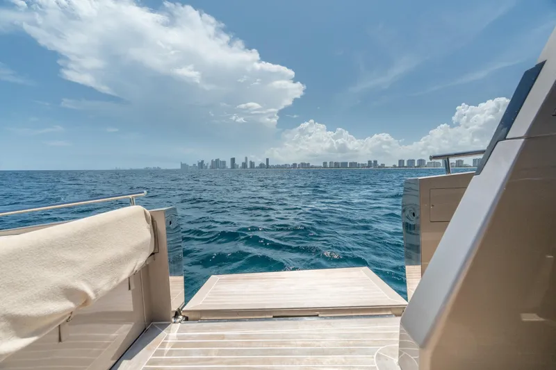 Slide: The Image of Luxury yacht CNM Continental 54, 2019 model, with ocean and city skyline view. - 19