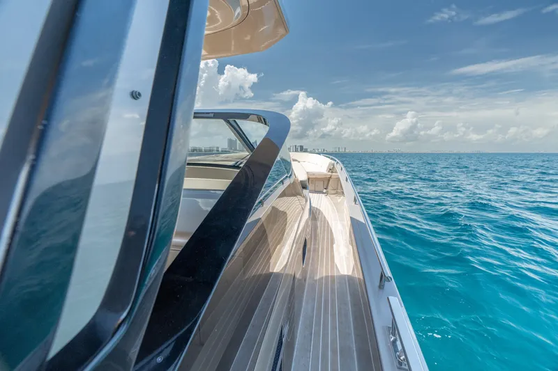Slide: The Image of 2019 CNM Continental 54 yacht cruising on clear blue ocean waters. - 35