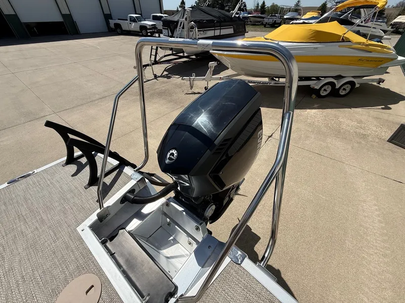 Slide: The Image of 2018 Bennington 25 SX boat with outboard motor on a parking lot. - 33