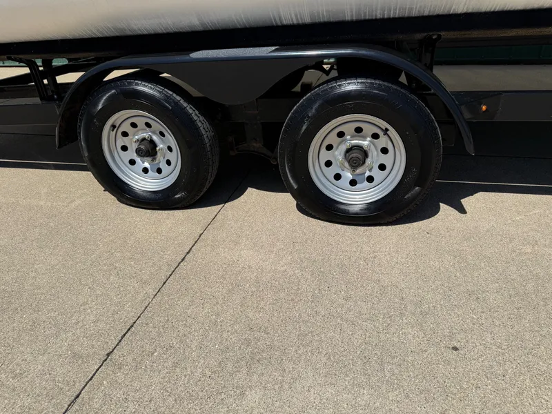 Slide: The Image of 2018 Bennington 25 SX trailer wheels on concrete surface. - 35