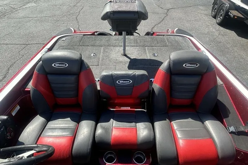 Slide: The Image of 2014 Triton 19XS boat interior with red and black seating, showcasing spacious design. - 10