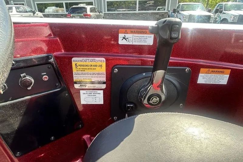 Slide: The Image of Control panel of a 2014 Triton 19XS boat with capacity warning labels. - 14