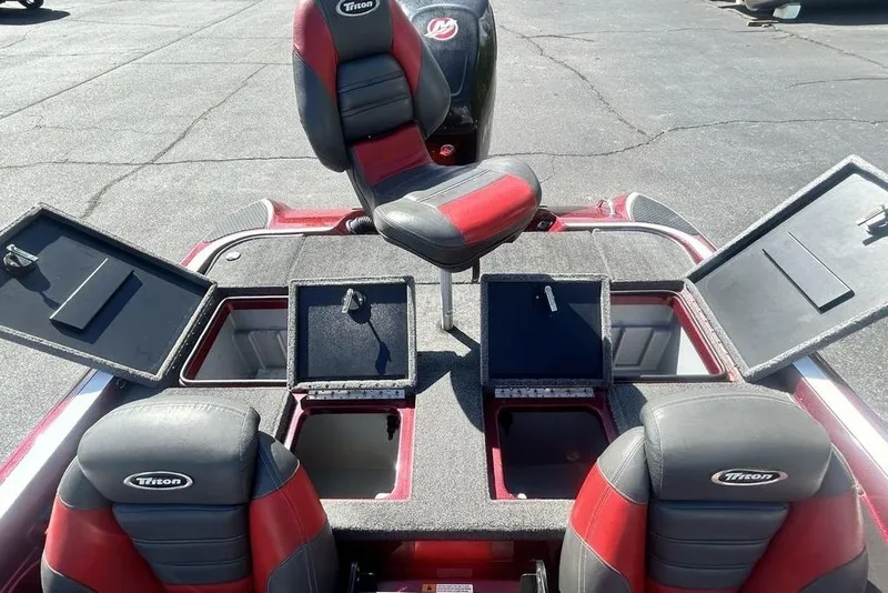 Slide: The Image of 2014 Triton 19XS boat interior with open storage compartments and seating. - 16