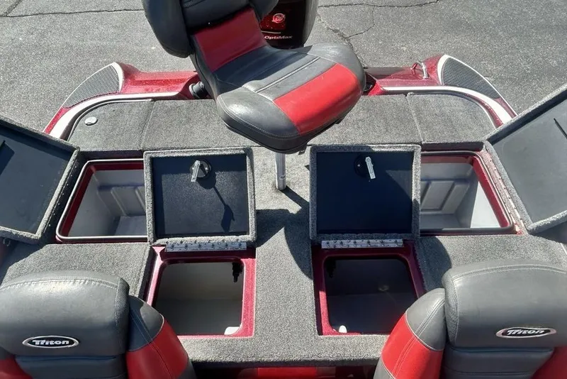 Slide: The Image of 2014 Triton 19XS boat interior with open storage compartments and seating. - 17