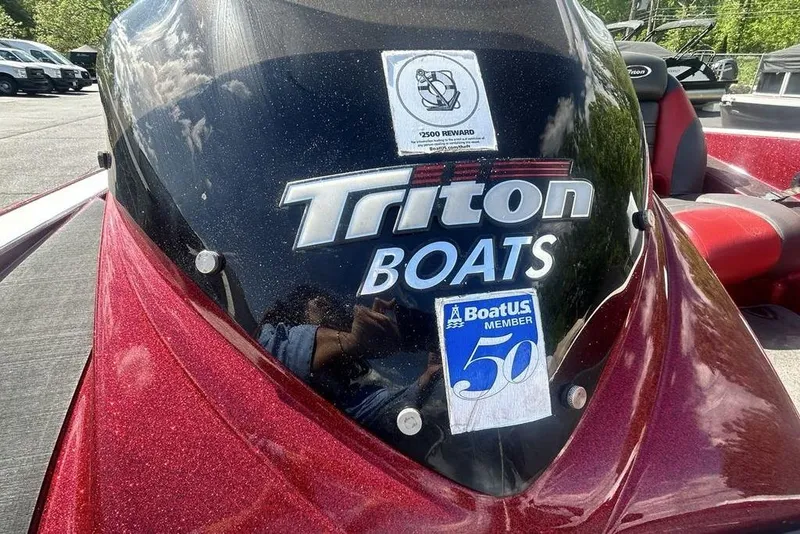 Slide: The Image of 2014 Triton 19XS boat with decals and red metallic finish. - 19