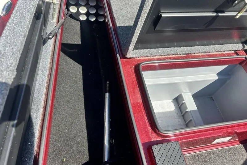 Slide: The Image of 2014 Triton 19XS boat storage compartments with rod holders and open hatch. - 5