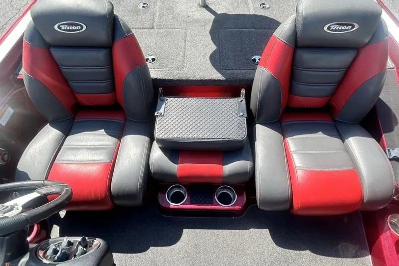 Slide: The Image of 2014 Triton 19XS boat interior with red and black seats and steering wheel. - 6