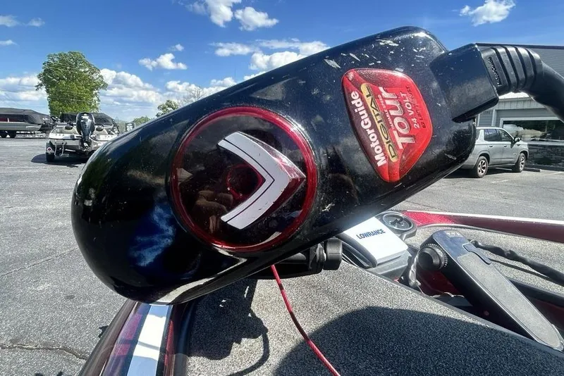 Slide: The Image of 2014 Triton 19XS boat with MotorGuide Tour motor, parked outdoors under a clear sky. - 7