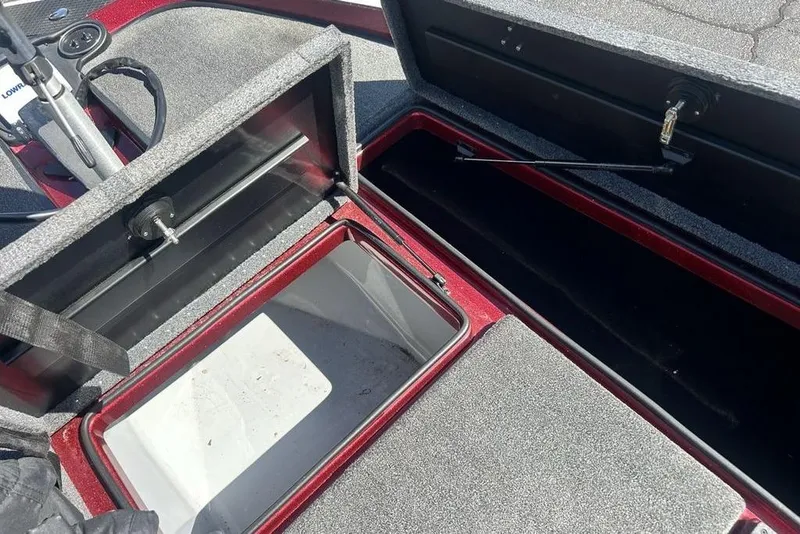 Slide: The Image of Open storage compartments on a 2014 Triton 19XS boat, showcasing interior space. - 9