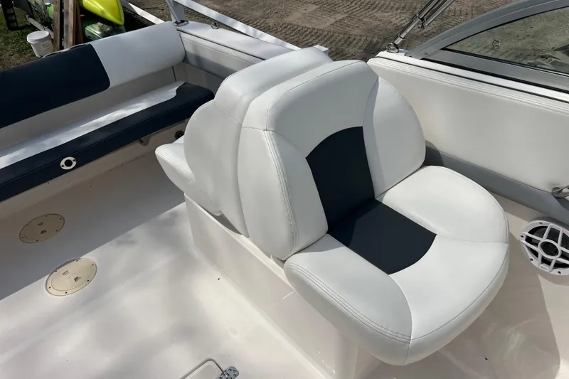 Slide: The Image of 2022 Robalo R227 Dual Console boat interior with white and black seating. - 12