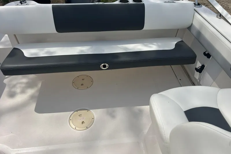 Slide: The Image of 2022 Robalo R227 Dual Console boat interior with white and gray seating. - 15