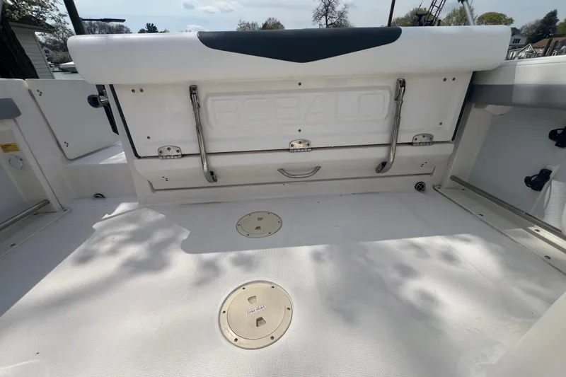 Slide: The Image of 2022 Robalo R227 Dual Console boat interior with storage compartments and seating. - 17
