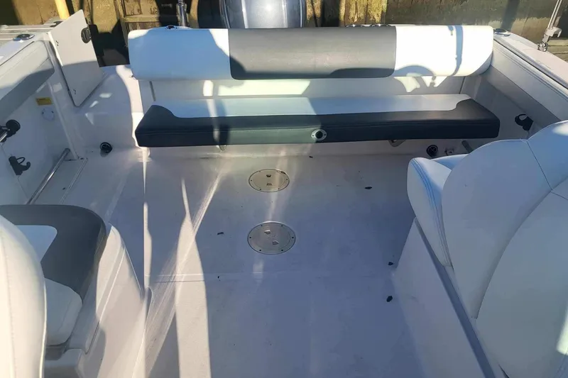 Slide: The Image of 2022 Robalo R227 Dual Console boat interior with seating and deck view. - 19