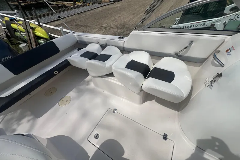 Slide: The Image of 2022 Robalo R227 Dual Console boat interior with white seating and sleek design. - 24
