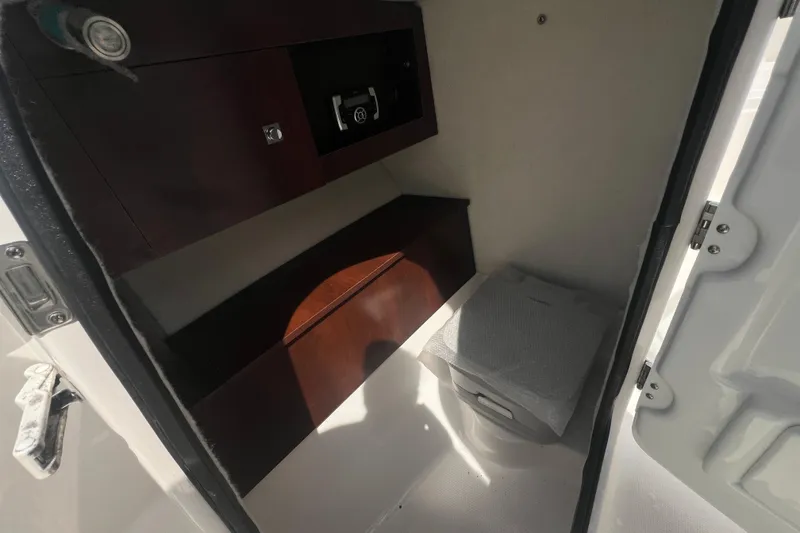 Slide: The Image of Interior cabin of 2022 Robalo R227 Dual Console boat with storage and seating. - 28