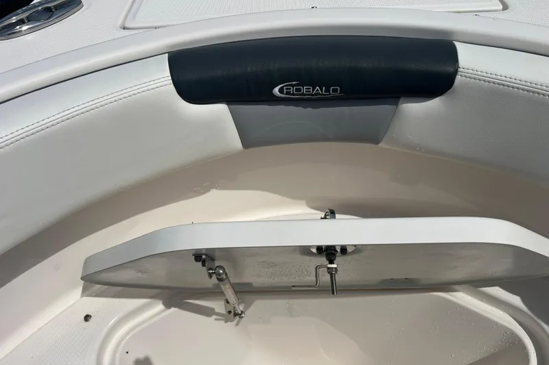 Slide: The Image of 2022 Robalo R227 Dual Console boat interior with storage compartment open. - 30