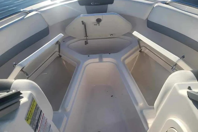 Slide: The Image of 2022 Robalo R227 Dual Console boat interior with open storage compartments. - 33