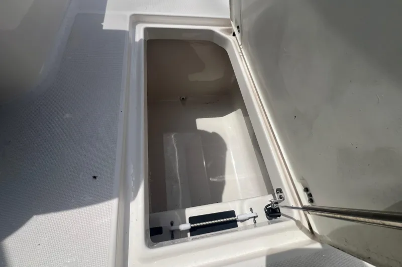 Slide: The Image of Open storage compartment in 2022 Robalo R227 Dual Console boat. - 36