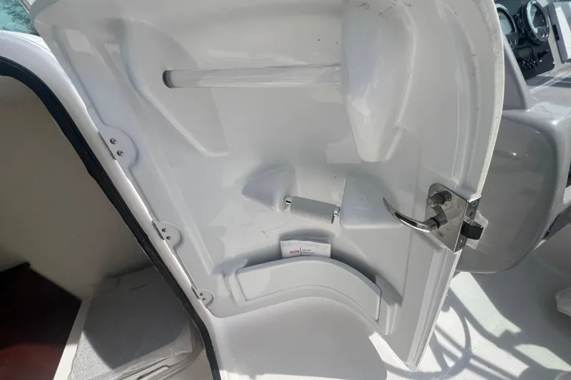 Slide: The Image of 2022 Robalo R227 Dual Console interior door with handle and storage compartment. - 38