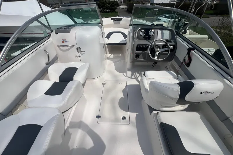 Slide: The Image of 2022 Robalo R227 Dual Console boat interior with white seating and modern dashboard. - 4
