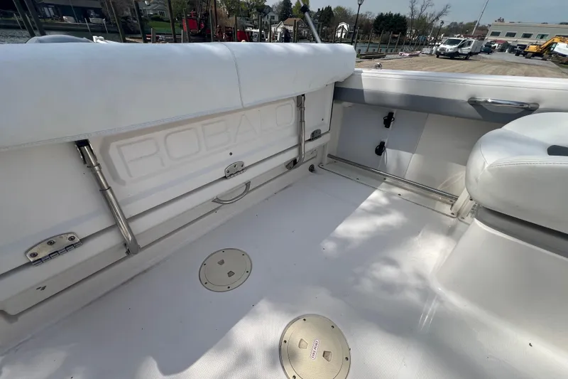 Slide: The Image of 2022 Robalo R227 Dual Console boat interior with white seating and deck details. - 41