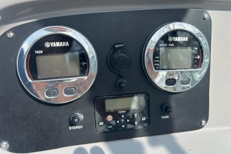 Slide: The Image of Yamaha gauges and controls on a 2022 Robalo R227 Dual Console boat dashboard. - 42