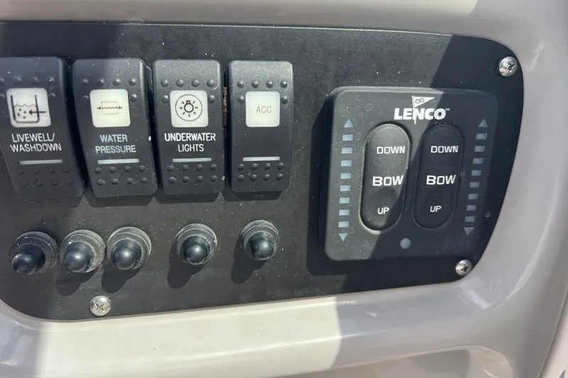 Slide: The Image of Control panel of 2022 Robalo R227 Dual Console with switches and Lenco trim tab controls. - 43