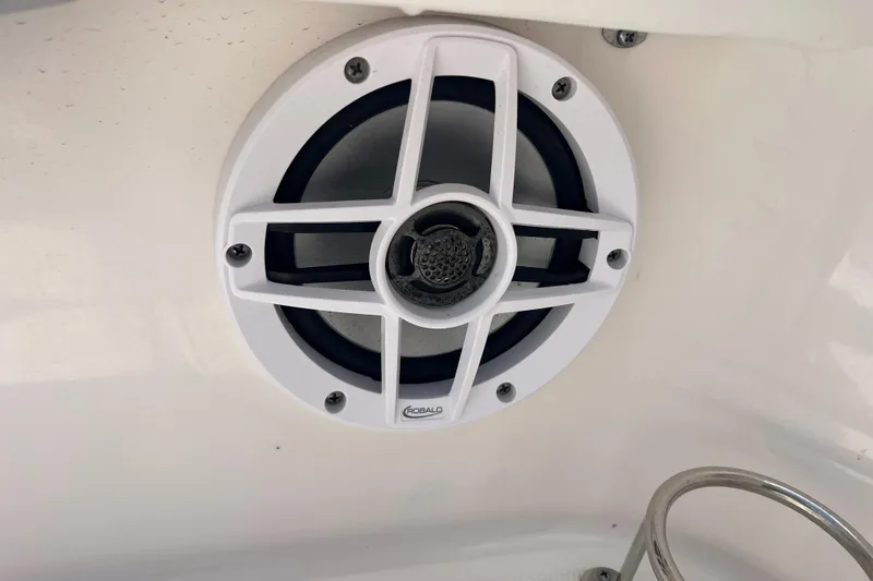 Slide: The Image of Speaker on 2022 Robalo R227 Dual Console boat, white casing, mounted on interior surface. - 45