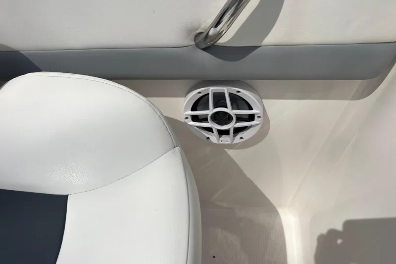 Slide: The Image of 2022 Robalo R227 Dual Console interior with speaker and seat detail. - 47