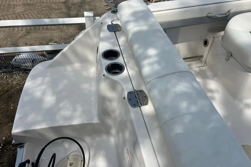 Slide: The Image of 2022 Robalo R227 Dual Console boat interior with cup holders and seating. - 48