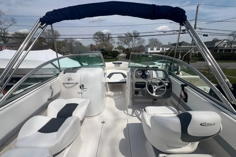 Slide: The Image of 2022 Robalo R227 Dual Console boat interior with steering wheel and seating. - 5