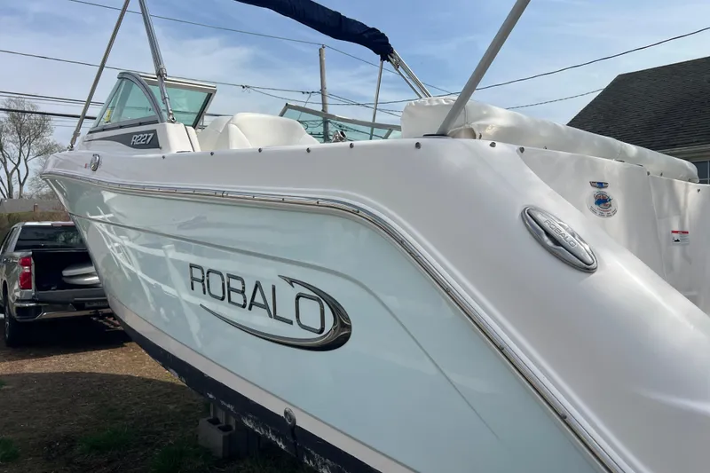 Slide: The Image of 2022 Robalo R227 Dual Console boat, white exterior, parked outdoors. - 53