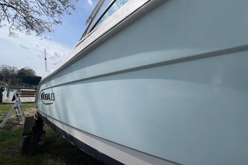 Slide: The Image of 2022 Robalo R227 Dual Console boat side view near dock. - 57