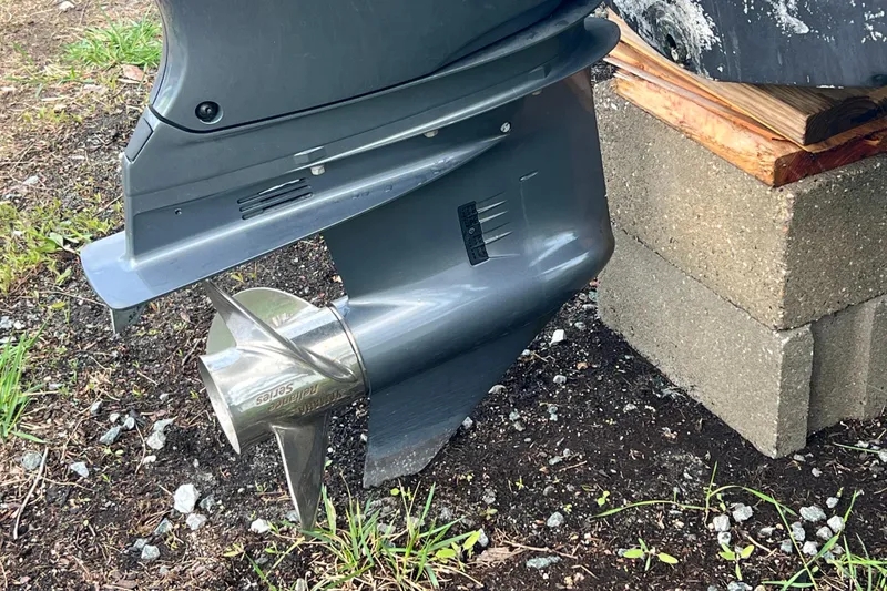 Slide: The Image of 2022 Robalo R227 Dual Console boat propeller on a concrete block. - 59