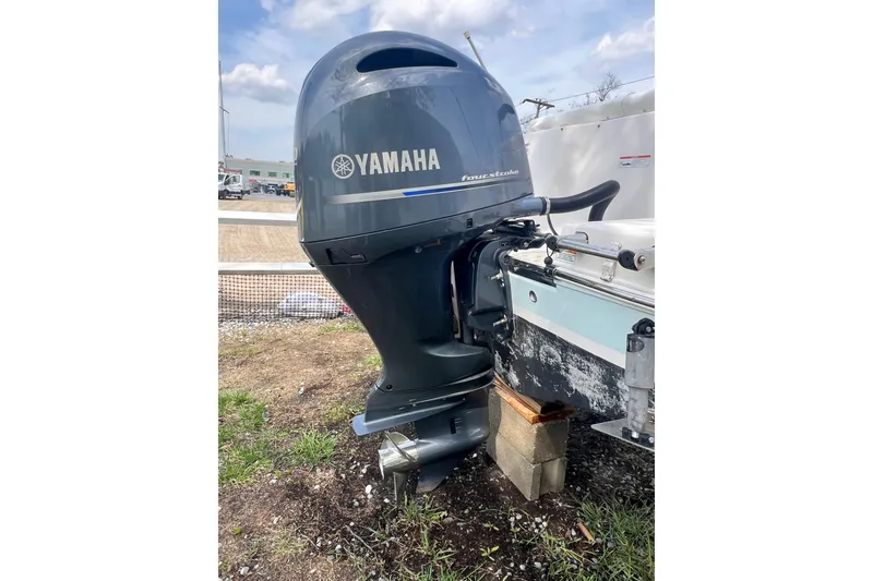 Slide: The Image of Yamaha outboard motor on 2022 Robalo R227 Dual Console boat, parked outdoors. - 60