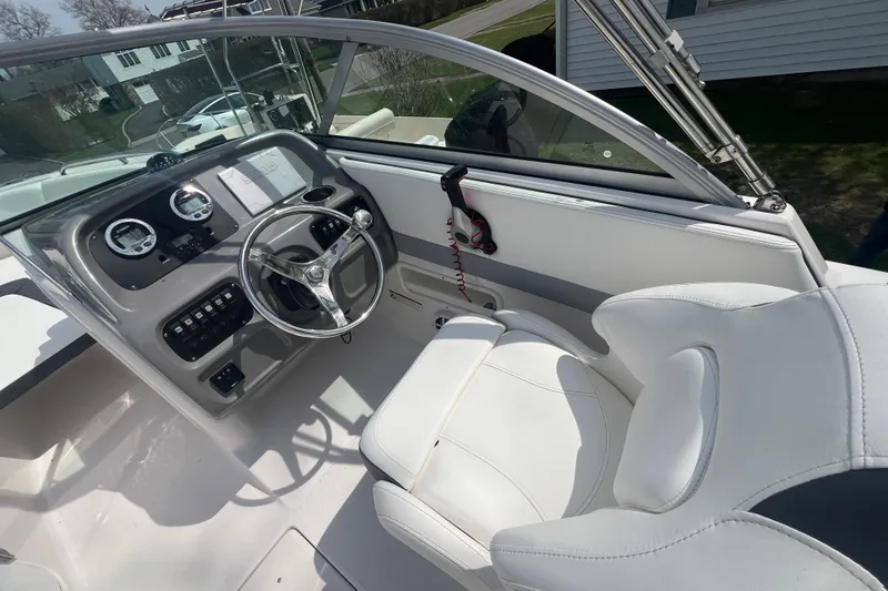 Slide: The Image of 2022 Robalo R227 Dual Console boat cockpit with steering wheel and controls. - 7